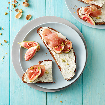 Pain aux noix foncé au Philadelphia herbes, figues juteuses et jambon de Parme